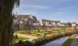a view of a castle with a garden and buildings at Ty brestivan in Theix