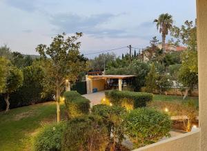a house with a garden with bushes and lights at Plepi's Seaside Villa in Plépi