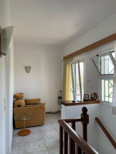 a living room with a couch and a table at Plepi's Seaside Villa in Plépi