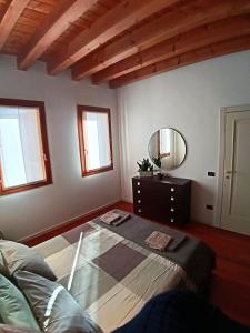 a bedroom with a bed and a dresser and a mirror at Dietro la piazza in Marostica