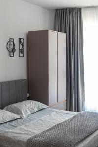 a bedroom with a bed and a cupboard at Salt & Serenity Apartment in Orikum