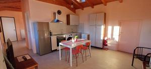 a kitchen with a table and chairs and a refrigerator at Casa del Moro al Sacro Monte app1 in Varese