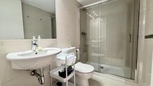 a bathroom with a toilet and a sink and a shower at Esglesia 7 2-4 in L'Estartit +13 photos