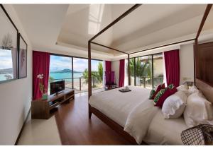 a bedroom with a large bed with a view of the ocean at Dhevatara Residence Beachfront Villas in Mae Nam +97 photos