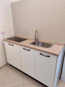 a kitchen with white cabinets and a sink at Enjoy Trani in Trani +40 photos