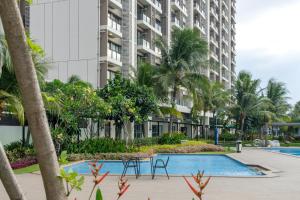 a view of the apartment complex from the swimming pool at Arka by TwoSpaces Studio @Skyhouse Apartment in Cilenggang