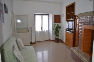 a living room with a couch and a tv at Casa Valentina in Brenzone sul Garda