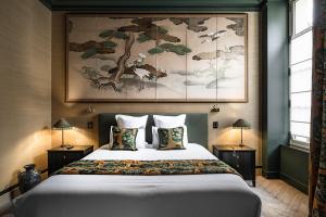 a bedroom with a large bed with two pillows at Maison Maubreuil in Nantes