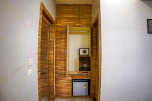 a hallway with a wooden wall with a mirror at Shubhham Regency in kolkata