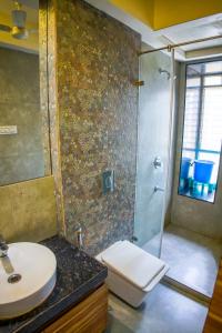 a bathroom with a shower and a toilet and a sink at Shubhham Regency in kolkata +37 photos