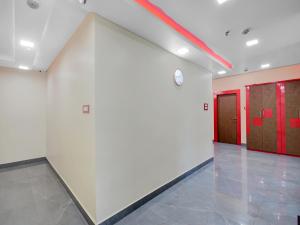 a large room with red doors and a wall at Hotel O THE CROWN COMFORTS in Kolkata