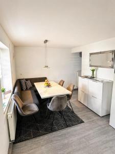 a kitchen and dining room with a table and chairs at Family & Work Apartment in Schopfloch +8 photos