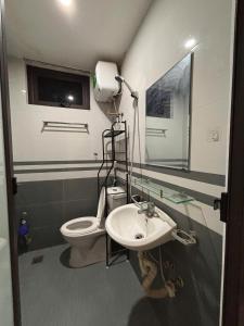 a bathroom with a toilet and a sink at Amoureux Cầu Diễn in Tây Tựu