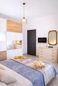 a bedroom with a large bed and a mirror at Il nido in Cecina +20 photos