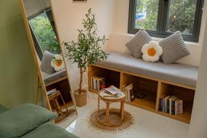 a living room with a bench and a potted plant at Sai Gon Stay-Hi-Tech Park Collection in Ho Chi Minh City