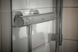 a mirror is attached to a glass door at Lindenau Inn in Leipzig +57 photos