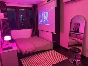 a pink bedroom with a bed and a mirror at Amoureux Cầu Diễn in Tây Tựu