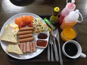 a plate of breakfast food with hot dogs and toast at P Bliss hotel in Phayao