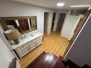 a living room with a large mirror and a wooden floor at Dúplex centro de Ribeira con WIFI by Cristian&Tamara"alquileres" in Ribeira