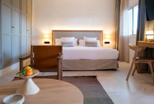 a bedroom with a large bed with white sheets and pillows at Can Jaume by Ocean Drive in Ibiza Town +156 photos