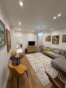 a living room with a couch and a table at Mikpritja Korçë in Korçë +23 photos