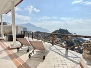 two chairs on a balcony with a view of the mountains at Villa Salice in Amalfi
