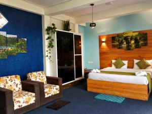 a hotel room with a bed and two chairs at Off grid Ella Homestay in Ella