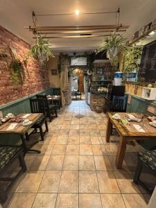 a restaurant with tables and chairs in a room at Avarest House BB Adults Only in Portrush