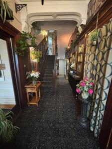 a hallway with flowers and plants on the walls at Avarest House BB Adults Only in Portrush