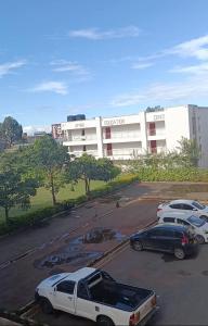 a parking lot with cars parked in front of a building at HM Royal Homes in Nairobi