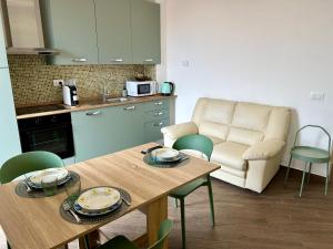 a kitchen and living room with a table and a couch at Il Colle in Sanremo +11 photos