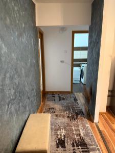 a living room with a couch and a hallway at Apart1 in Drobeta-Turnu Severin