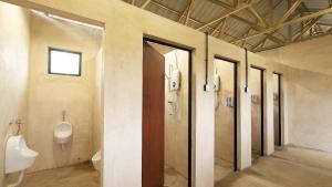 a bathroom with four urinals and a urinal and a toilet at Suka Camping - Bentong in Bentong