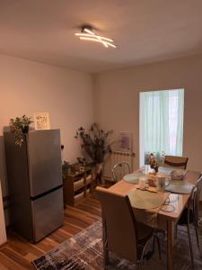 a kitchen and dining room with a table and a refrigerator at Apart1 in Drobeta-Turnu Severin