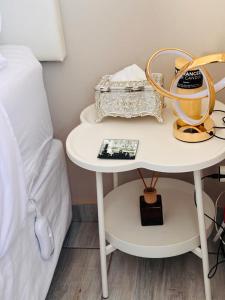 a white table with a basket on it next to a bed at Sunset Heaven in Newcastle +16 photos