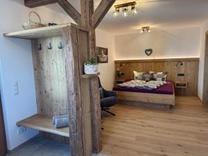 a bedroom with a bed and a wooden floor at Winkelfeldhof in Eglfing +83 photos