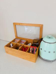 a wooden box with a tea kettle next to it at Sunset Heaven in Newcastle