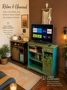 a living room with a tv on top of a table at Greytree Cottage in Ross on Wye