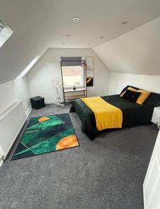 a attic bedroom with two beds and a rug at The Pilgrims Cove in Burnham on Sea