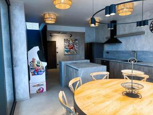 a kitchen with a wooden table and chairs in a room at Vila CampoAmor Pasohlávky in Pasohlávky