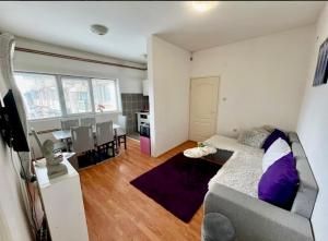 a living room with a couch and a dining room at Centar S in Pirot
