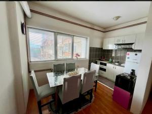 a kitchen with a table and chairs in a kitchen at Centar S in Pirot +1 photo