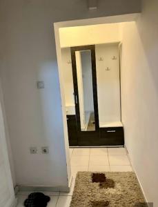 a bathroom with a mirror and a rug at Centar S in Pirot