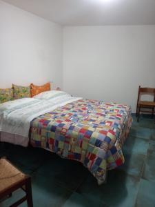 a bed with a colorful quilt on it in a room at Casa Serena 2 in Scanno