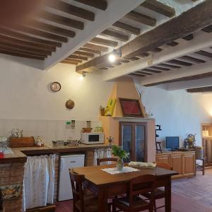 a kitchen with a wooden table and a tableasteryasteryasteryasteryasteryasteryastery at House with stunning views in Chiusdino