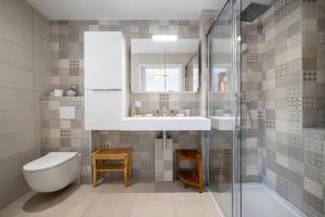 a bathroom with a sink and a toilet and a mirror at Le Coq Elysium - Exceptional 220 sqm Penthouse - Private Terrace & Jacuzzi - AC - 3 Parking Spaces in Menton +67 photos