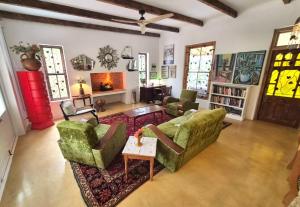 a living room with two couches and a fireplace at Django's in Riebeek-Kasteel
