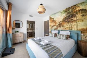 a bedroom with a large bed with a painting on the wall at Le Coq Elysium - Exceptional 220 sqm Penthouse - Private Terrace & Jacuzzi - AC - 3 Parking Spaces in Menton