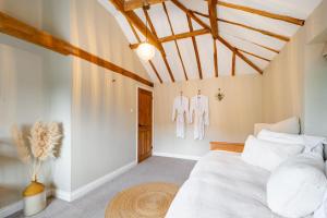 a bedroom with a bed and two mannequins at The Cottage at Tuffon Hall in Sible Hedingham