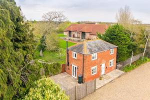 an aerial view of a brick house with a fence at The Cottage at Tuffon Hall in Sible Hedingham